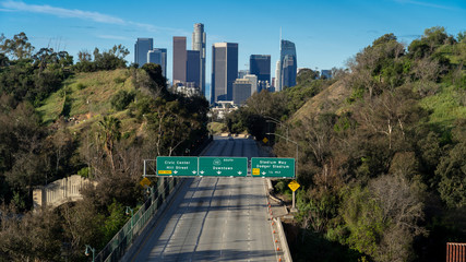 Aerial view of empty or vacant freeway facing downtown Los Angeles in California USA with no people and no cars on the road.