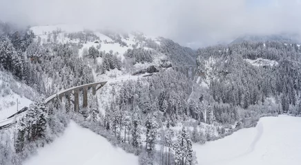 Photo sur Plexiglas Viaduc de Landwasser Aerial View of the Landwasser Viaduct with Railway without famous train at winter, landmark of Switzerland, snowing, river and mountains