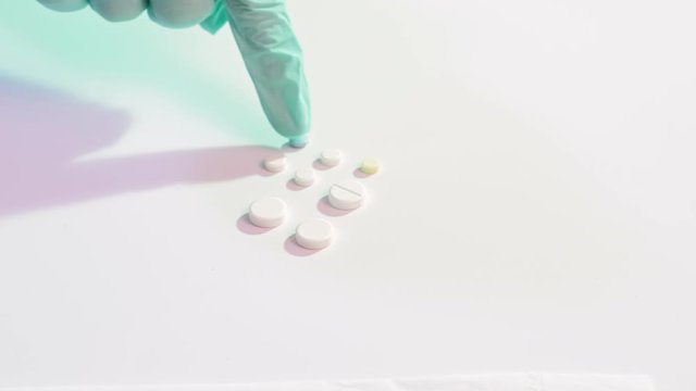 SARS infection. Combination therapy. Doctor hand in protective glove counting pills.