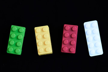 Toys traffic light and a white paracetamol tablet on a black background