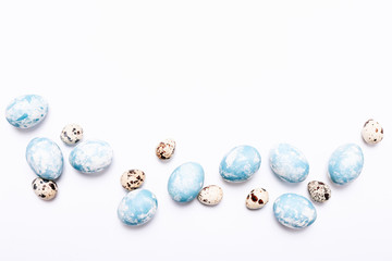 Stylish eggs with ombre blue marble stone effect on white background