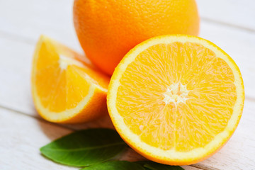 Orange fruit on wooden background - Fresh orange slice half and orange leaf healthy fruits harvest concept