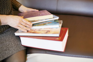 Fototapeta premium woman looks through books, stay home