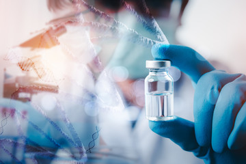 double exposure of doctor or scientist in laboratory holding a syringe with liquid vaccines for...