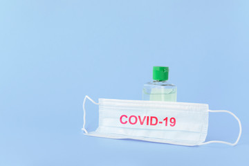 medical mask to protect against covid-19 flu with gel hand sanitizer, coronavirus concept