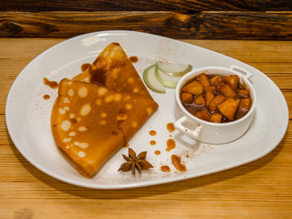Delicious hot pancakes with various fillings on the table. Before serving in a cafe