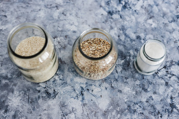 non-perishable food ingredients for vegan pantry, glass jars with oats flour and rice