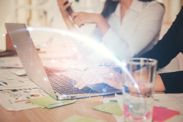Double exposure of woman hands typing on computer and social network theme hologram drawing. People...