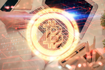 Double exposure of woman hands typing on computer and crypto market theme hologram drawing....