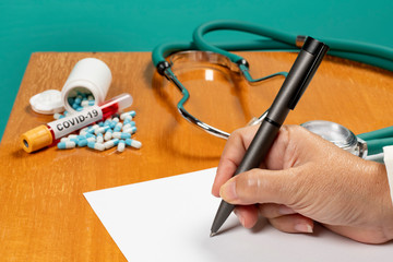 Hand of a doctor filling out form