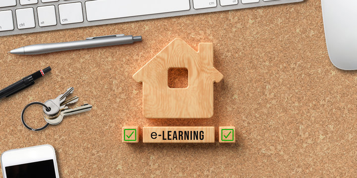 wooden blocks message E-LEARNING and computer equipment on cork background