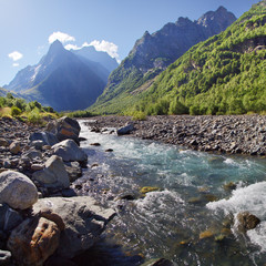 Clear water of a mountain river, Northern Caucasus. Beautiful mountain landscape, summer morning.	
