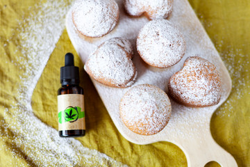 Cannabis oil and cupcakes with marijuana, medical marijuana concept, CBD oil