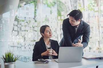 Group of young asian modern business people talking and smiling during the meeting in office.