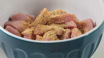 Chopped raw pork meat with garlic and herb  seasoning. Close up in a bowl, ready for cooking