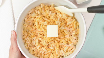 Creamy delicious macaroni and cheese close up in a bowl, view from above
