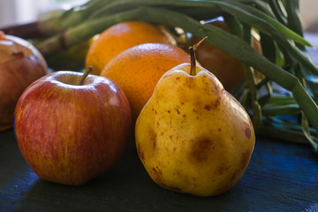 A pear and some fruits and vegetables