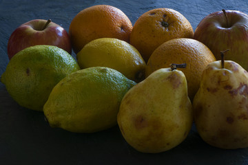 A group of fruits. Lemons, oranges and apples