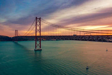 Fototapeta na wymiar Lisbon, Portugal. Aerial view of the 25 de Abril Bridge (Ponte 25 de Abril, 25th of April Bridge) at sunset. It is often compared to the Golden Gate Bridge in San Francisco, US.