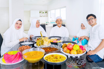 Happy muslim family smiling together in dining room
