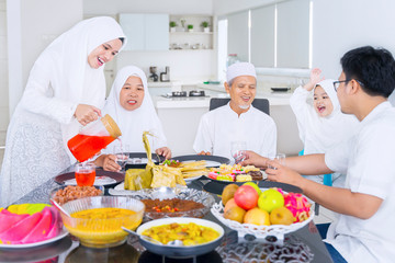 Muslim family eating together in dining room