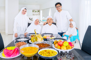 Muslim family smiling at camera together