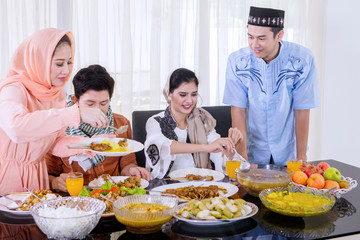 Muslim people having dinner in dining room