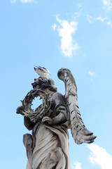 Fototapeta premium Angel Carrying the Crown of Thorns by Gian Lorenzo Bernini and a seagull stand on the top statue at Castel Sant'Angelo, Rome, Italy