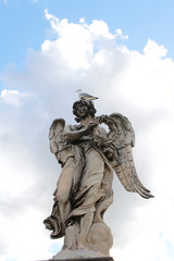 Fototapeta na wymiar Angel Carrying the Crown of Thorns by Gian Lorenzo Bernini and a seagull stand on the top statue at Castel Sant'Angelo, Rome, Italy