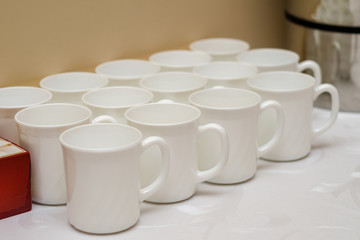 white ceramic mugs on the table