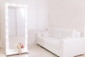 Large mirror with white frame in bright room