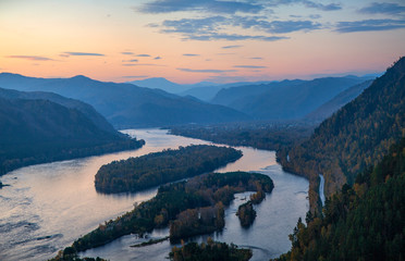 Fototapeta na wymiar The Yenisei River flows through a picturesque valley. Sunrise in the mountains. South of Western Siberia.