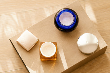 Two open cosmetic crream jars on gift box