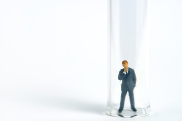 Health conceptual miniature people photography – testing specimen, a businessman on a laboratory tube