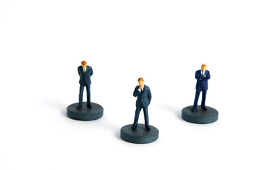 miniature people toy photography. A businessman standing above circle podium 