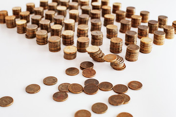 photo of Russian money with a face value of 10 rubles. Many Russian coins are displayed in columns, some of the coins are scattered. On white background