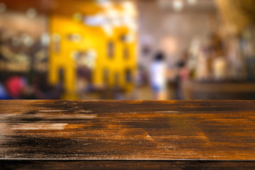 Empty wood table on abstract of blurred restaurant background