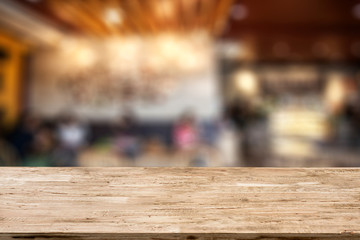 light brown wood table on blurred restaurant background