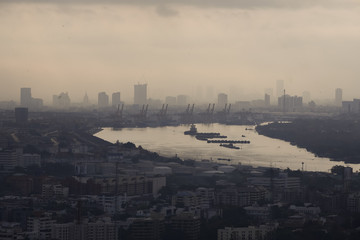 Morning moment of bangkok river bend with cityscape and industrail docks