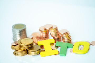 Miniature people: Internet of thing and stack of coins with copy space for text using as background saving, investment, money, financial, business analytics concept.