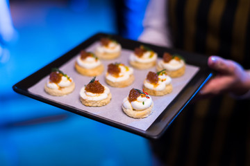mini cracker canepe appetizer serve on wooden platter