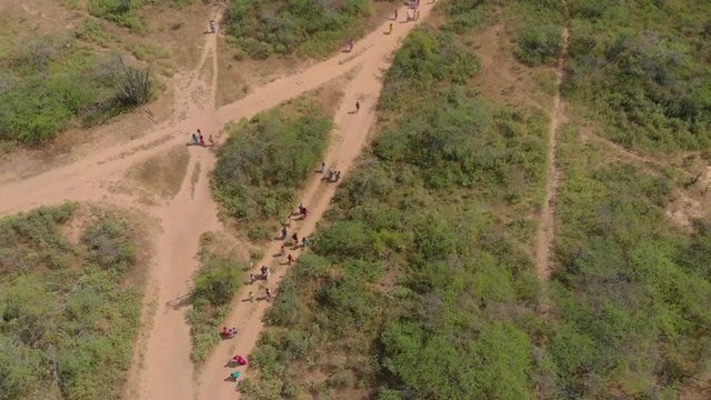 Aerial view of a Group of People Walking Through a village, Drone footage, 4k, indigenous people, Colombia, Guajira