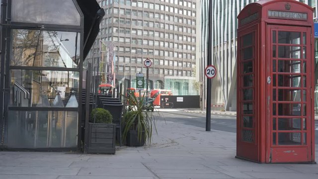 A closed pub and a red telephone booth.