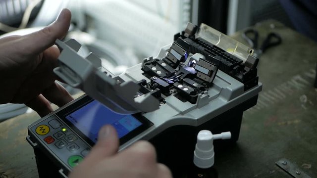 Telecommunications engineer working with optical coupling