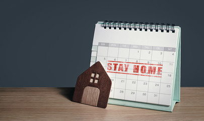 advice and alert on staying at home during social distancing. planning routine schedules of working or learning from home on a calendar to defense and avoid coronavirus infection. background for text.
