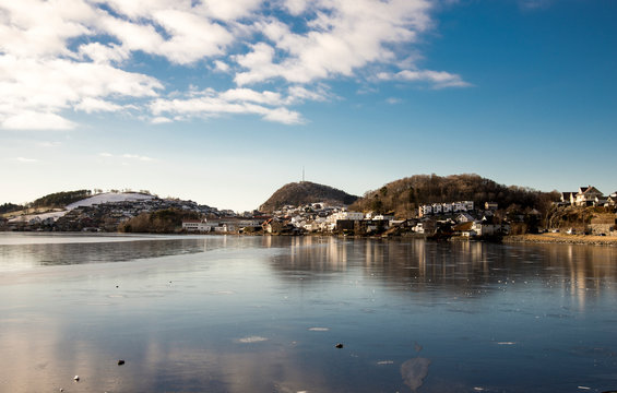 A view of Algard town and frozen waters of Edlandsvatnet lake in winter season, Norway, February 2018