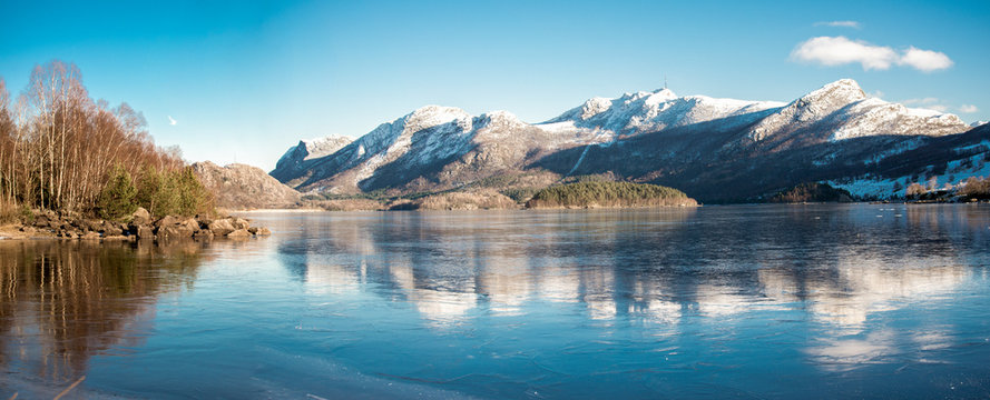 A view of mountains covered by snow at Oltedalsvatnet lake during winter season, Gjesdal commune, Norway, February 2018