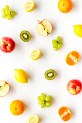 Colorful fruit pattern. Cut apple, kiwi, citrus on white background top-down
