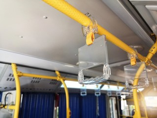 Clear Plastic bus grab handle.Clear Plastic hanging handhold for standing passengers in a modern...