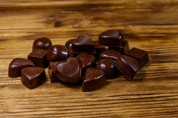 Tasty chocolate candies on wooden table